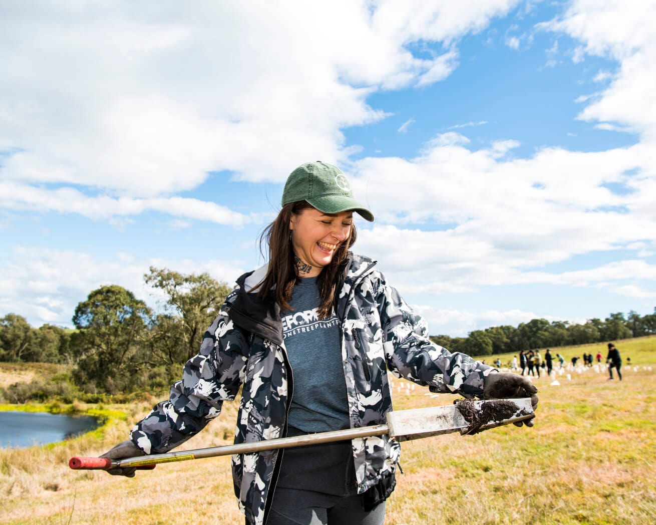 Woman holding a shovel with dirt